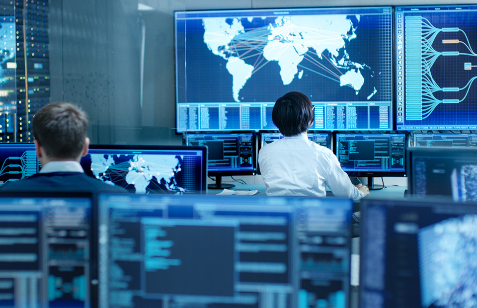 Control center with two employees sitting in front of screens